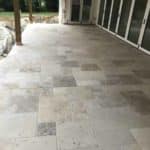 Stone-look outdoor tiles installed on a covered residential patio