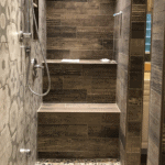 shower with wood-like tile and built in bench