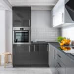 Elegant kitchen interior with brick tiles and modern cupboards
