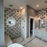 bathroom with patterned tile wall