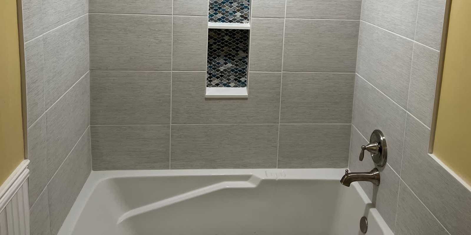 walk-in shower tile design with glass enclosure and porcelain tiles
