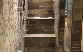 shower with wood-like tile and built in bench